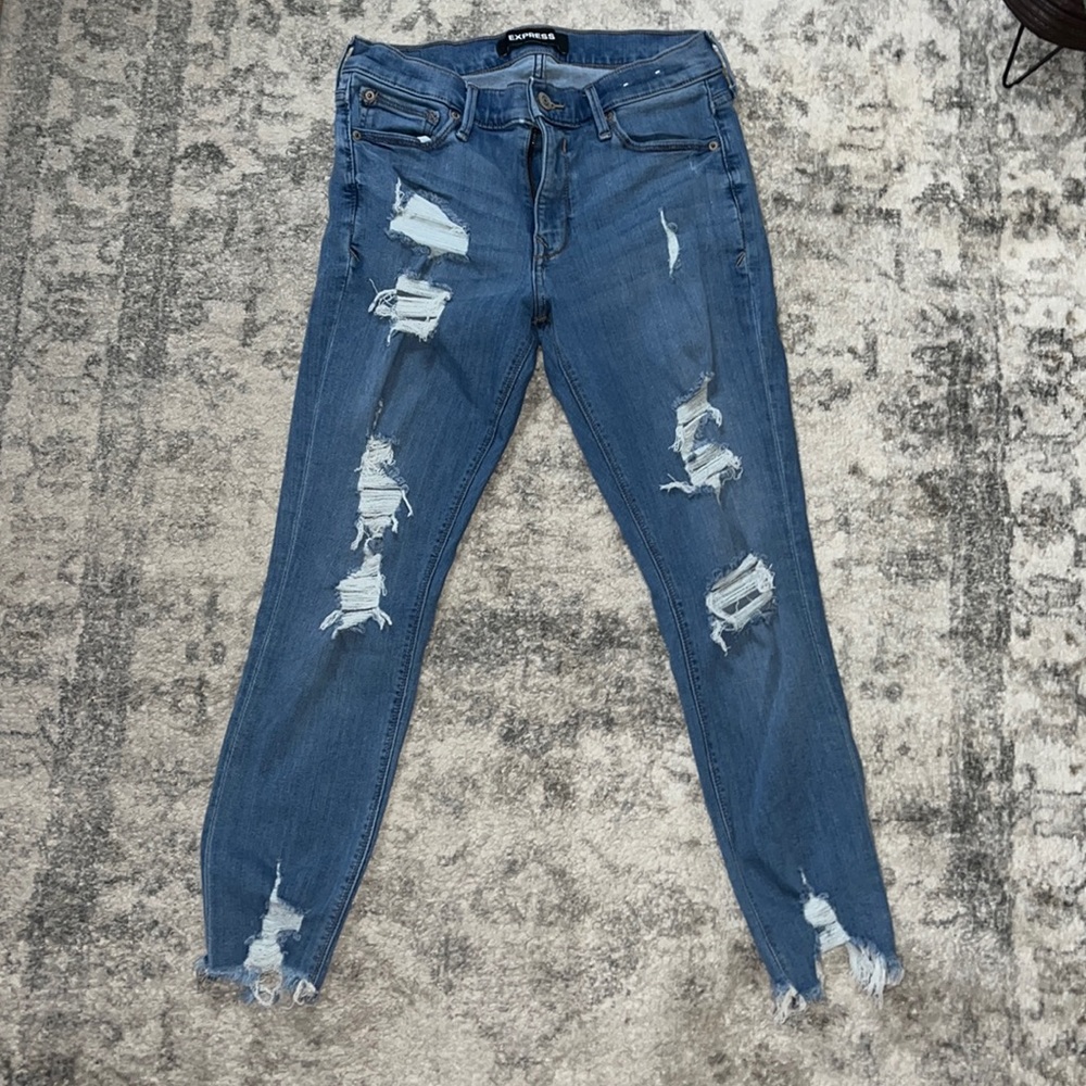 Stretchy Distressed Express Blue Jeans in a size 8Short